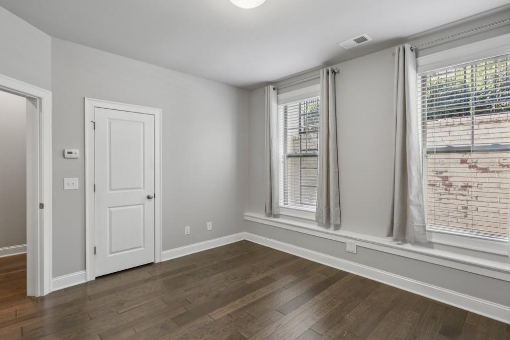 3899 Glenview Club Lane Duluth, GA 30097 - Photo 32 of 38 a view of an empty room with wooden floor and a window