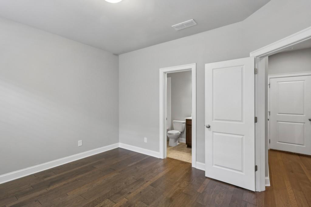 3899 Glenview Club Lane Duluth, GA 30097 - Photo 33 of 38 a view of an empty room with wooden floor