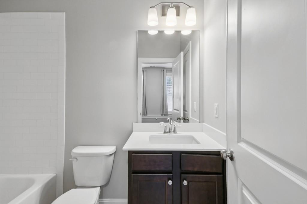 3899 Glenview Club Lane Duluth, GA 30097 - Photo 34 of 38 a bathroom with a sink and a toilet