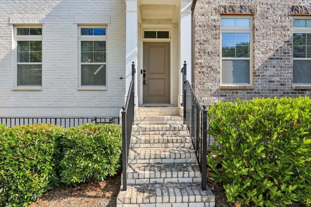 3899 Glenview Club Lane Duluth, GA 30097 - Photo 8 of 38 a front view of a house with a garden