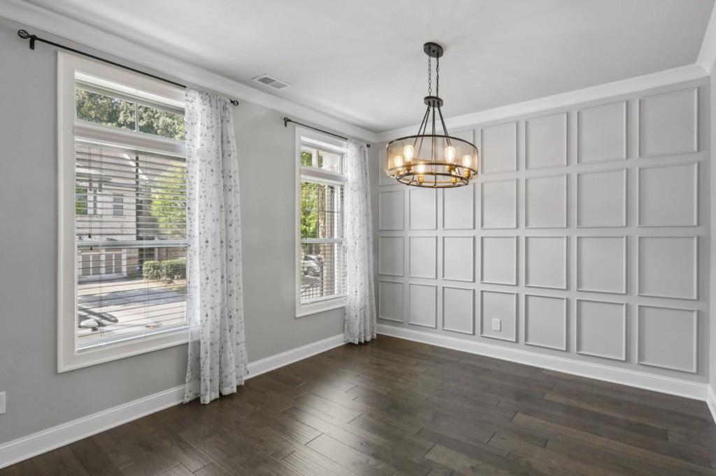 3899 Glenview Club Lane Duluth, GA 30097 - Photo 10 of 38 an empty room with wooden floor fan and windows