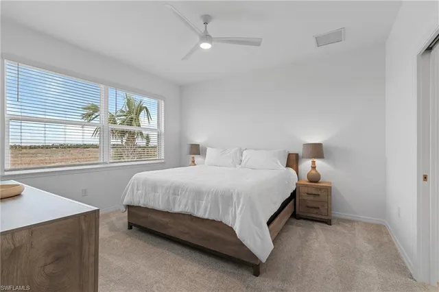 a bathroom with a granite countertop sink a toilet and a mirror
