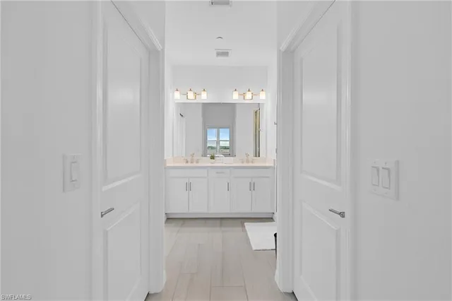 a bedroom with a bed and a night stand