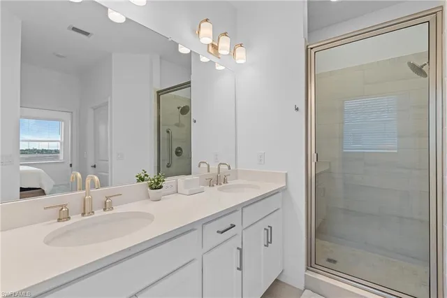 a bathroom with a granite countertop sink toilet a large mirror and shower