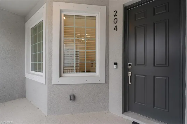 a view of a hallway with furniture and wooden floor