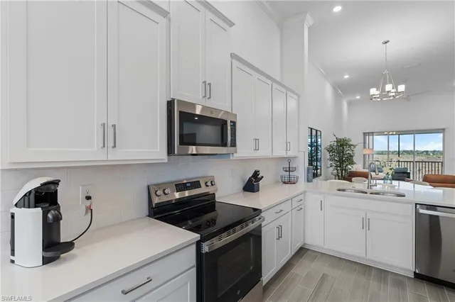 a view of a dining room with furniture and chandelier