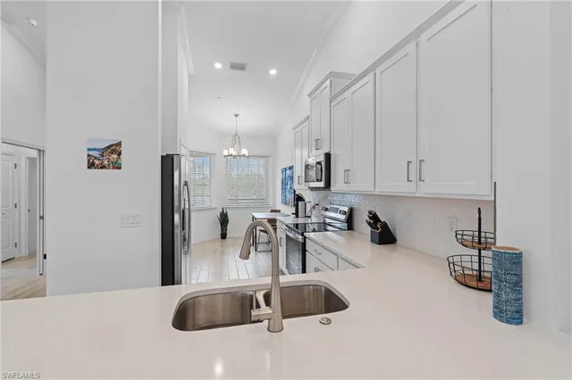 a dining room with furniture and a chandelier