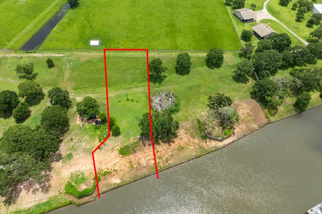 an aerial view of residential houses with outdoor space and swimming pool