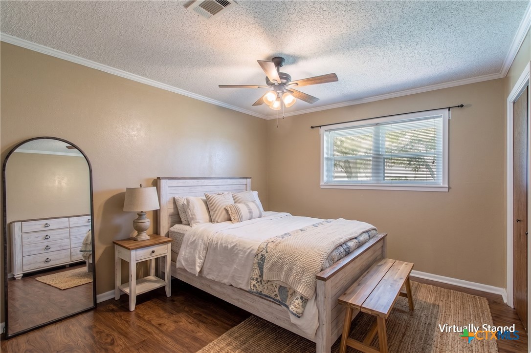 3053 Hobby Creek Road Burlington, TX 76519 - Photo 23 of 40 a bedroom with a bed and a chandelier