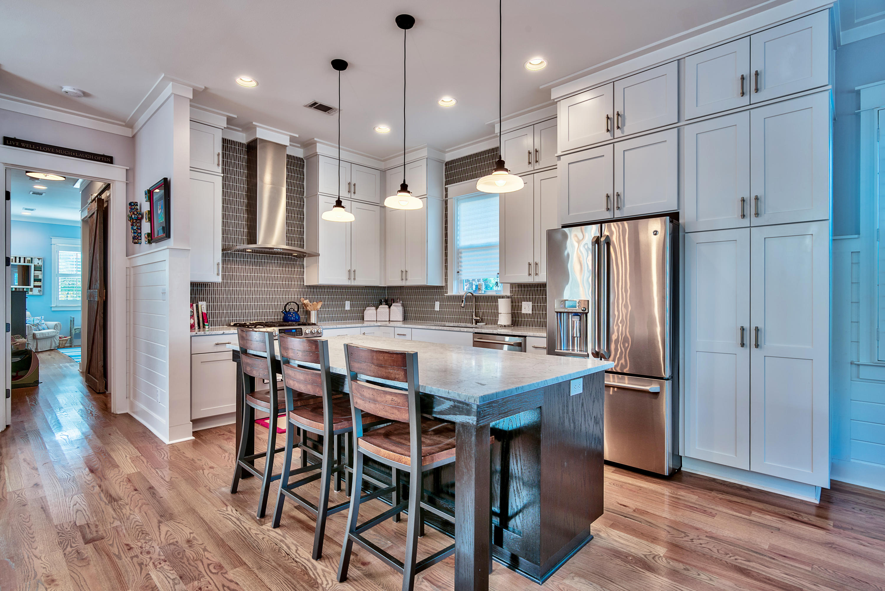 19 Dune Ridge Road Santa Rosa Beach, FL 32459 - Photo 2 of 29 a kitchen with stainless steel appliances refrigerator dining table and chairs
