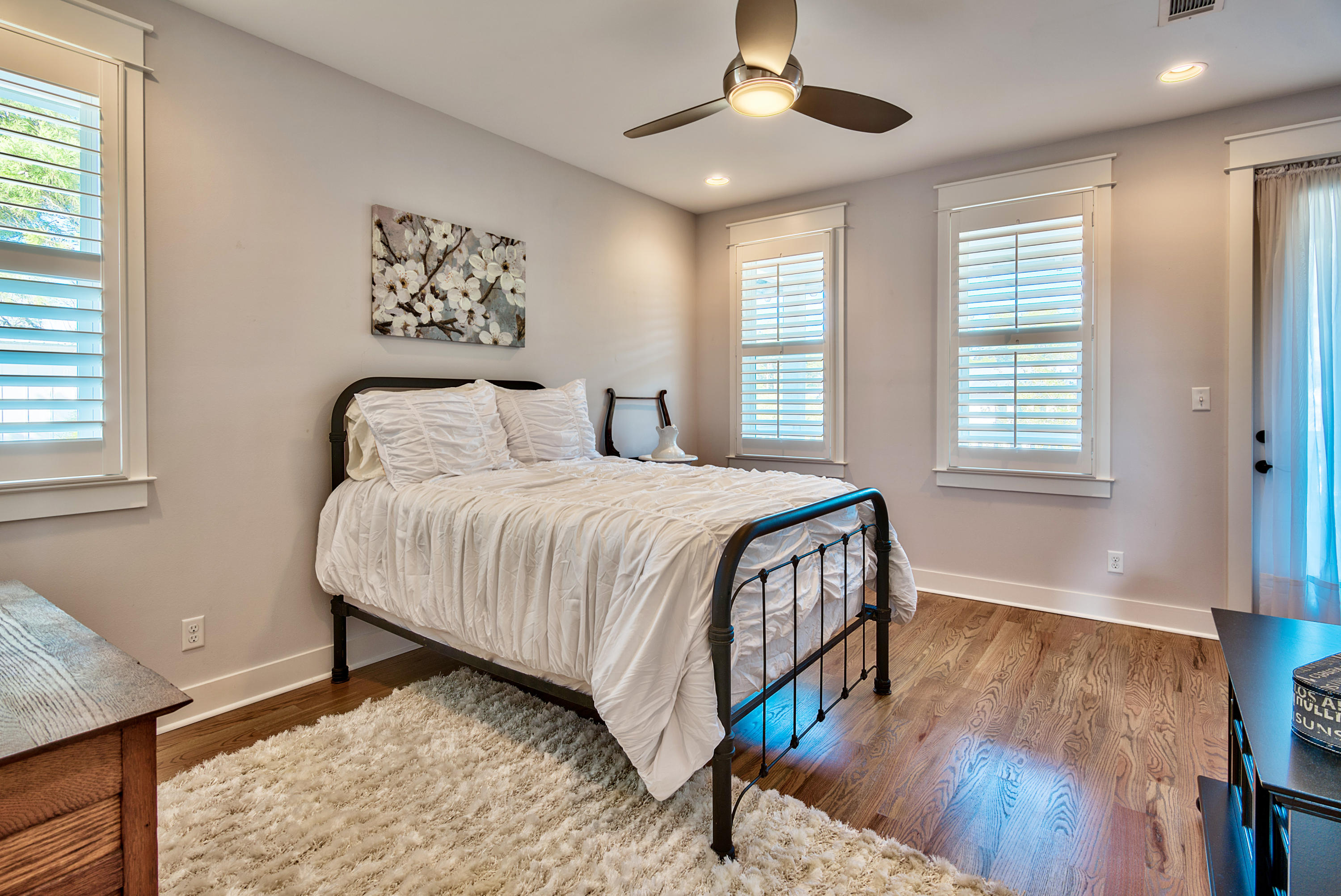 19 Dune Ridge Road Santa Rosa Beach, FL 32459 - Photo 15 of 29 a bedroom with a large bed a chandelier and a window