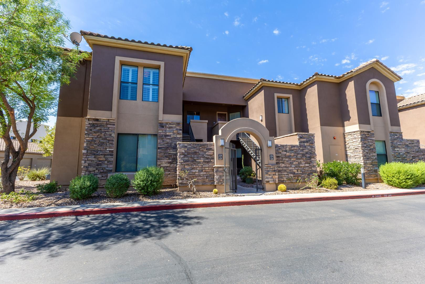 7027 North Scottsdale Road, Unit 225 Scottsdale, AZ 85253 - Photo 16 of 48 a front view of a house with a yard