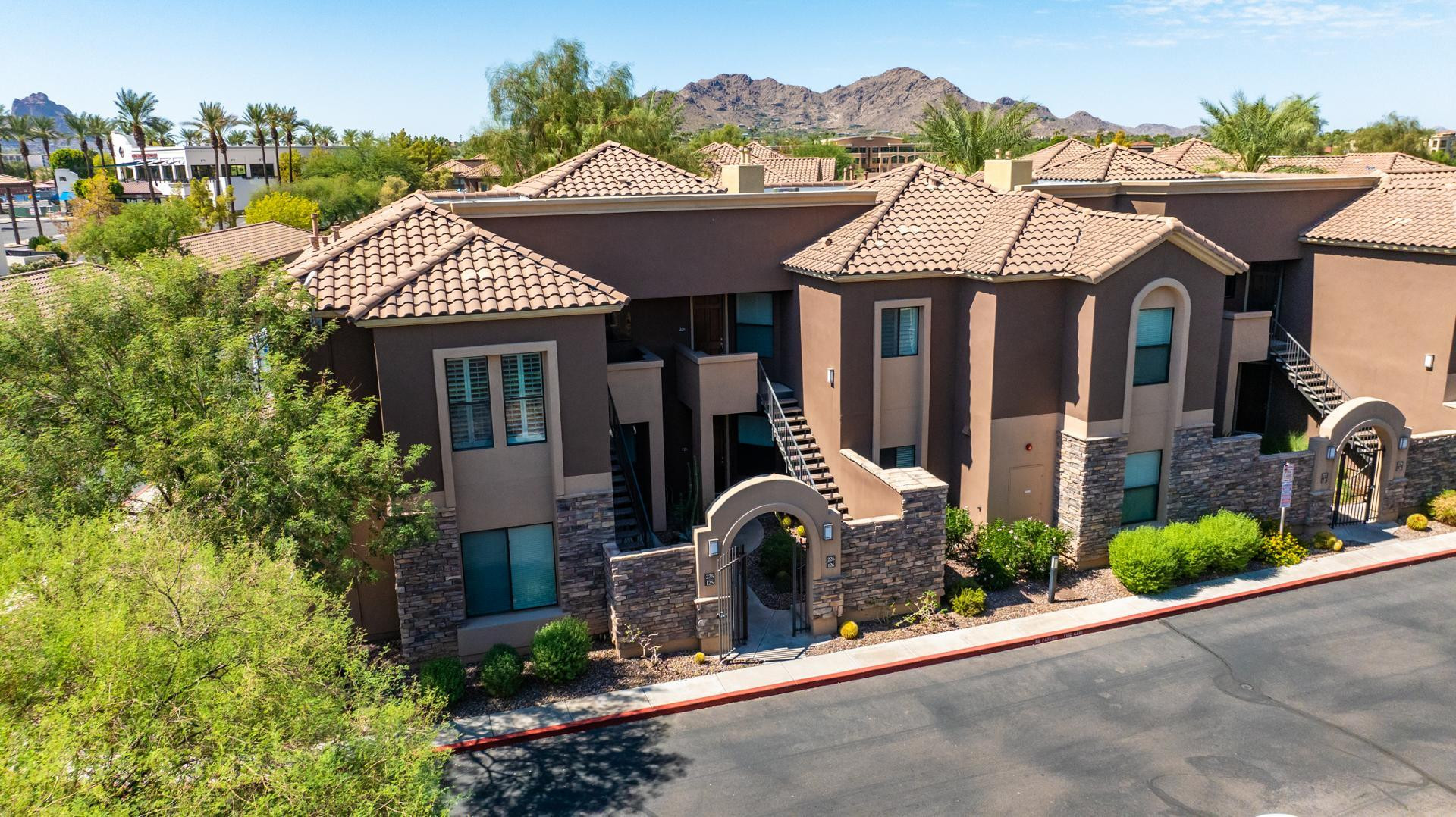 7027 North Scottsdale Road, Unit 225 Scottsdale, AZ 85253 - Photo 35 of 48 a front view of a house with a yard