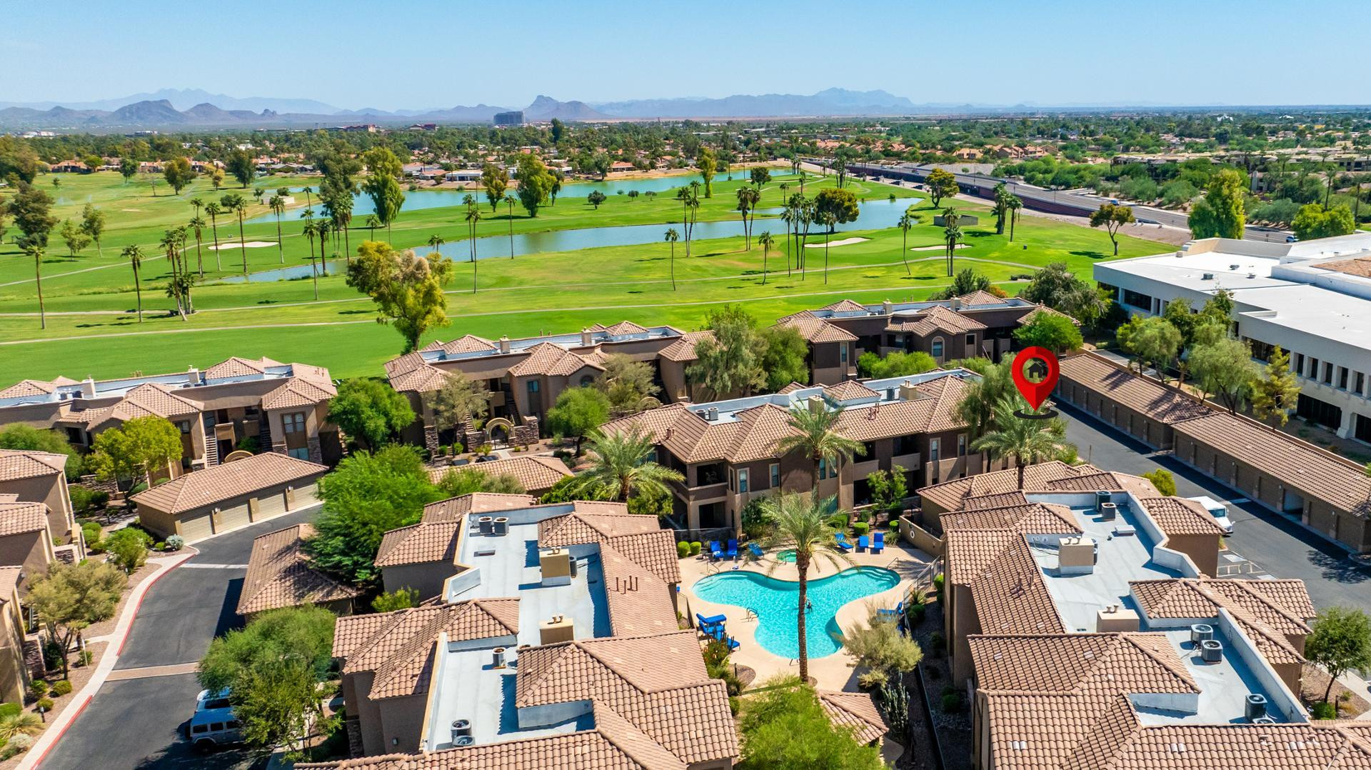 7027 North Scottsdale Road, Unit 225 Scottsdale, AZ 85253 - Photo 45 of 48 an aerial view of a city with lots of residential buildings and mountain view in back
