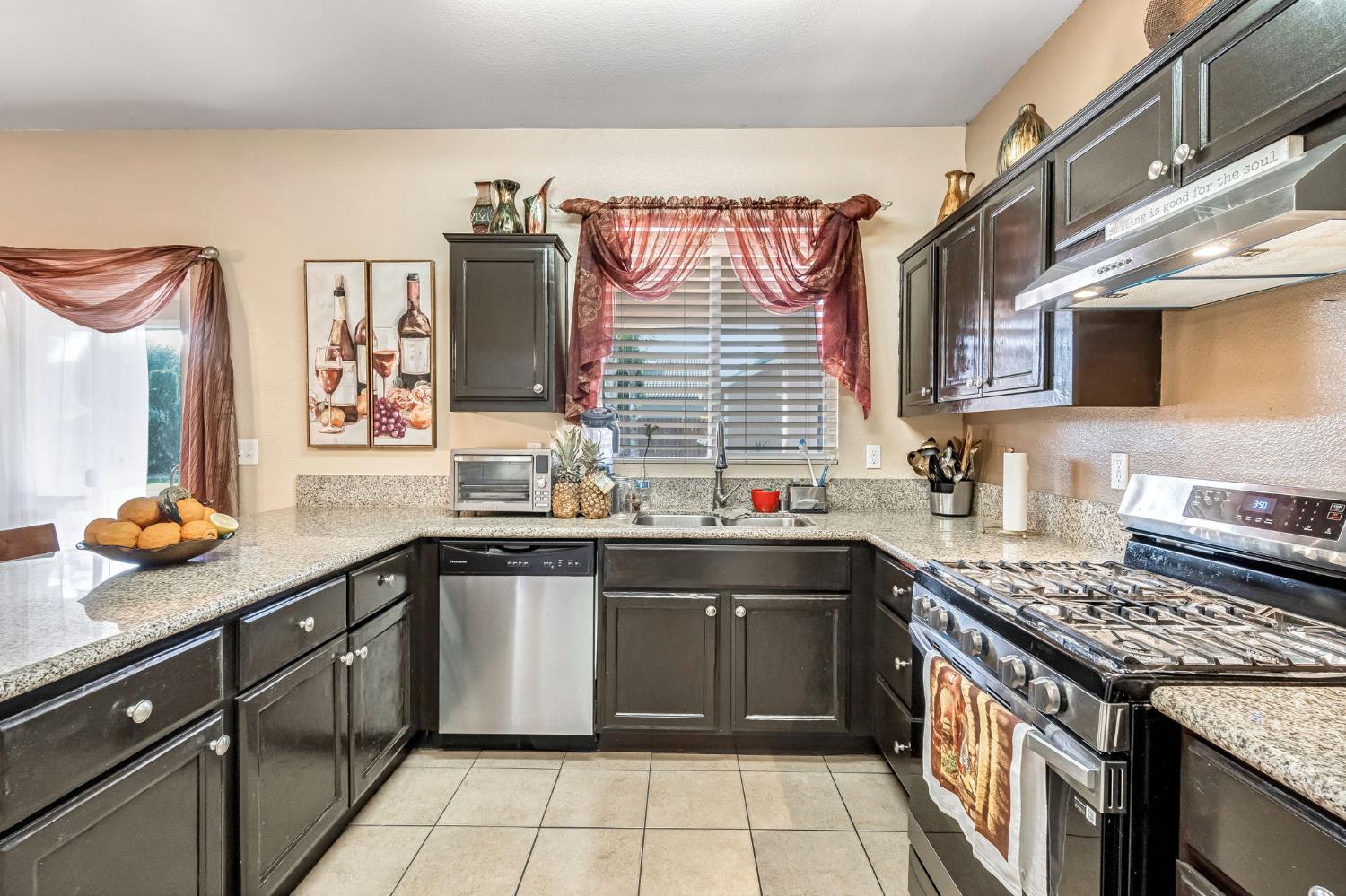 877 Sandra Avenue Sanger, CA 93657 - Photo 14 of 40 a kitchen with stainless steel appliances granite countertop a stove sink and cabinets
