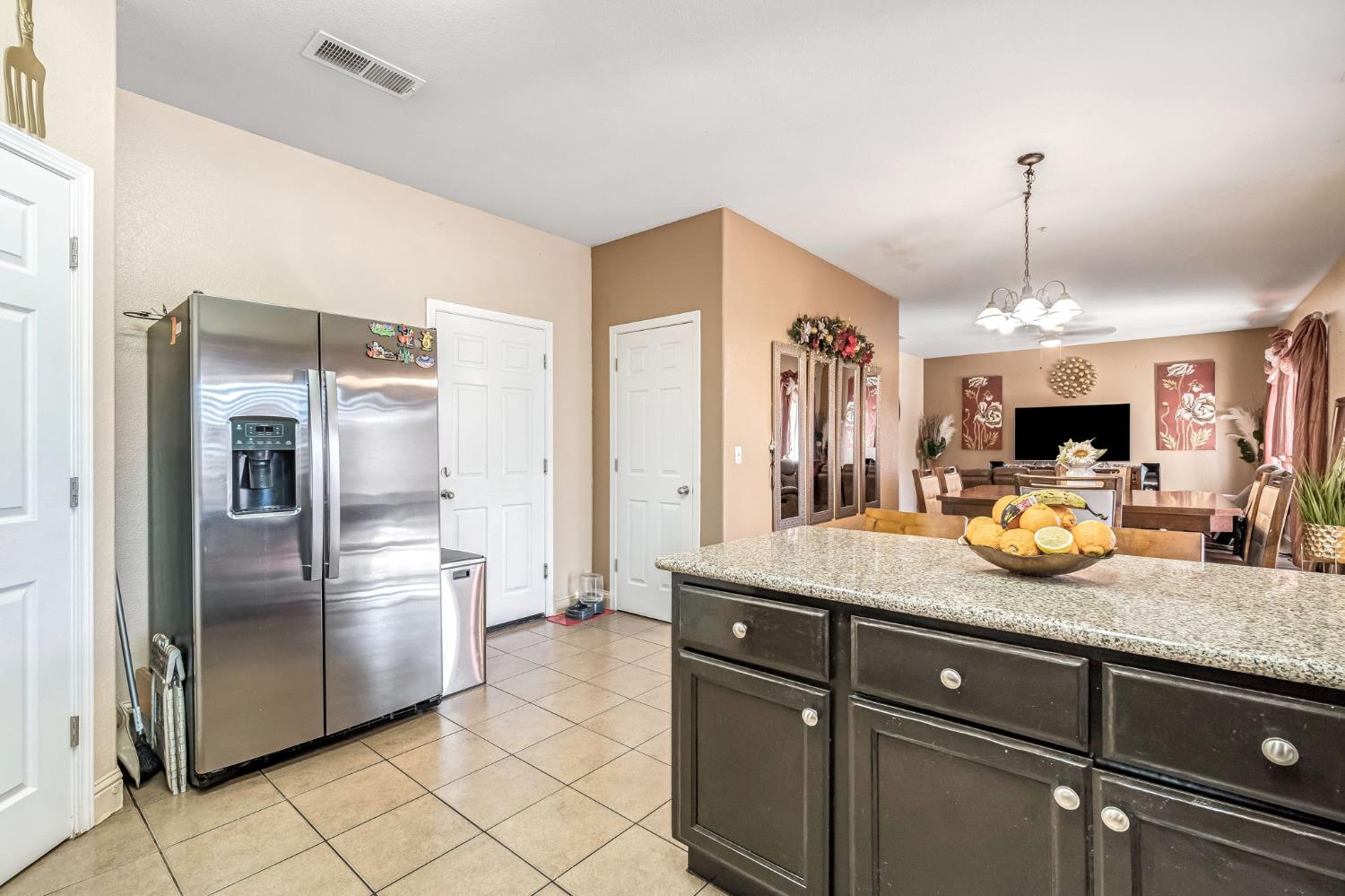 877 Sandra Avenue Sanger, CA 93657 - Photo 15 of 40 a kitchen with a refrigerator and microwave