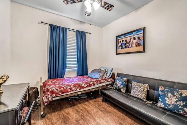 a bedroom with a bed and a chandelier