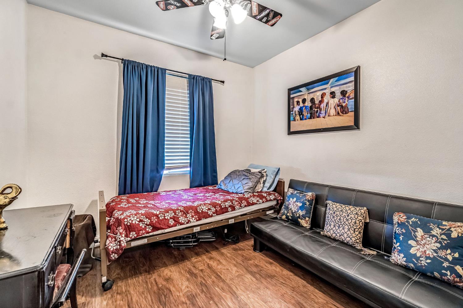 877 Sandra Avenue Sanger, CA 93657 - Photo 17 of 40 a bedroom with a bed and a chandelier