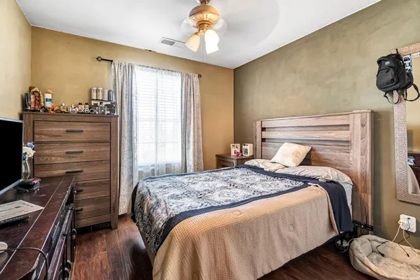 a bedroom with a bed and a chandelier