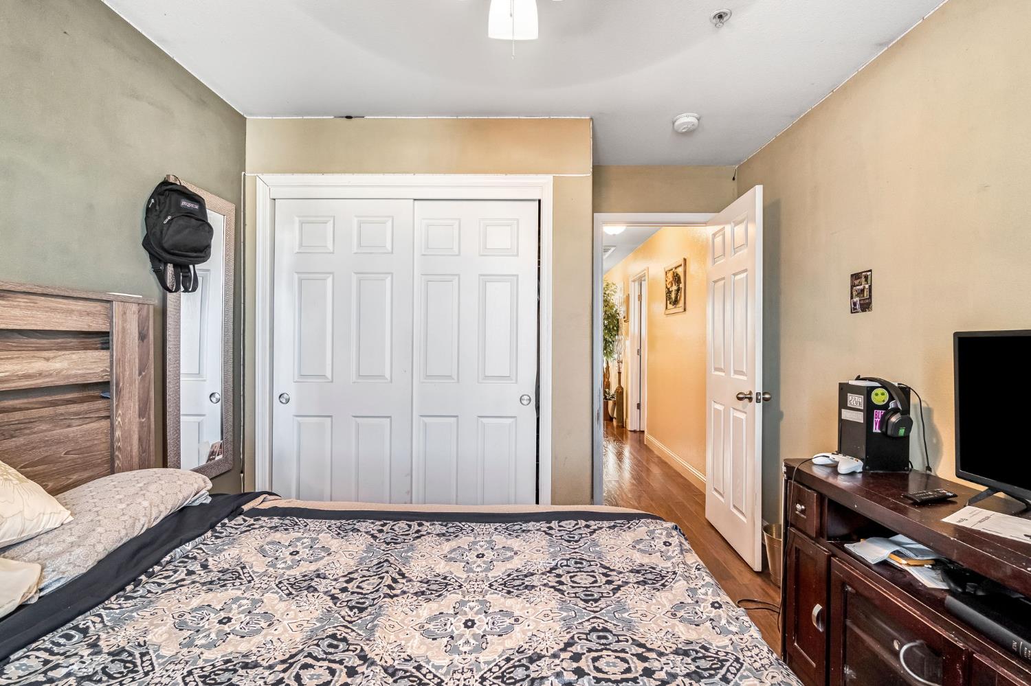 877 Sandra Avenue Sanger, CA 93657 - Photo 21 of 40 a bedroom with a bed and a flat screen tv