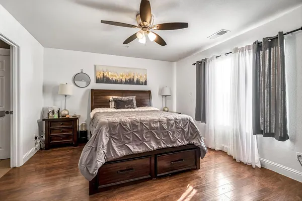 a bedroom with a bed and a window