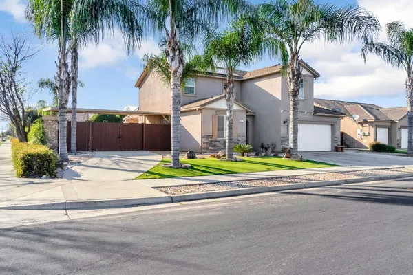 a house with palm tree in front of it
