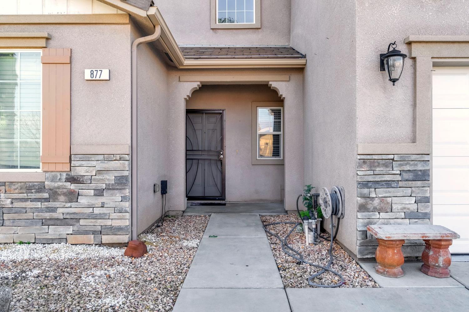 877 Sandra Avenue Sanger, CA 93657 - Photo 5 of 40 a view of front door of house with potted plants