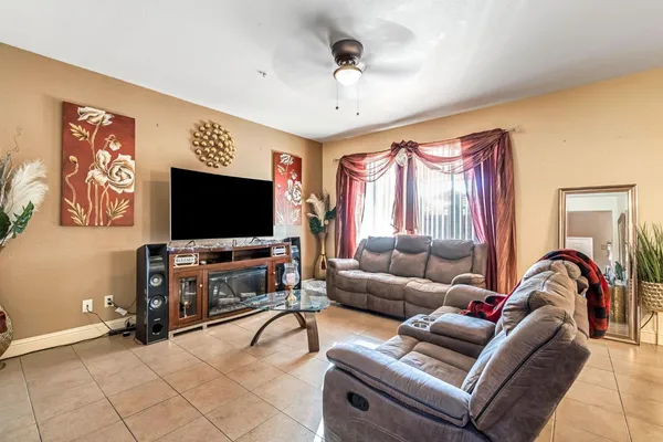a living room with furniture and a flat screen tv