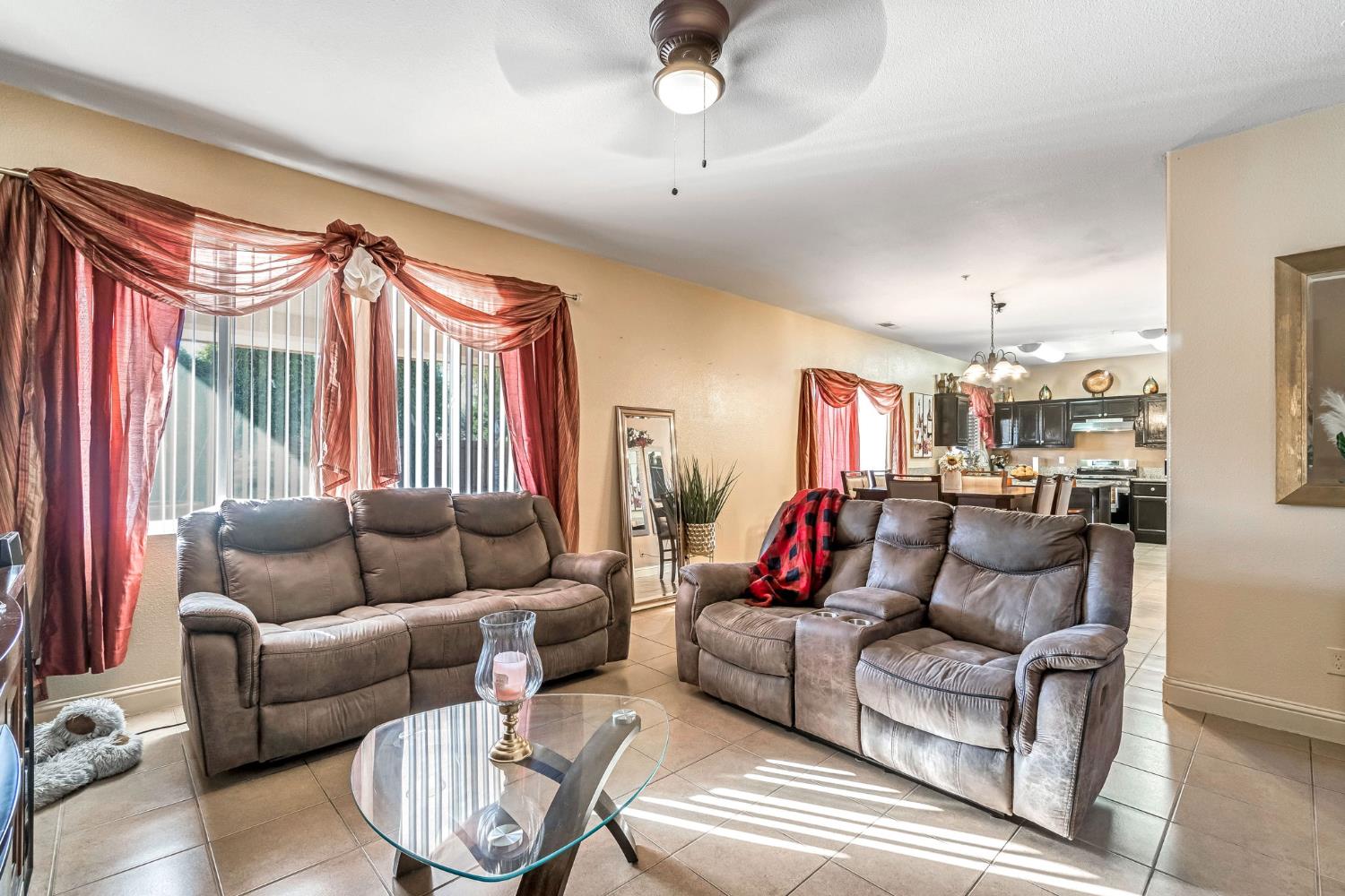 877 Sandra Avenue Sanger, CA 93657 - Photo 9 of 40 a living room with furniture ceiling fan and a rug