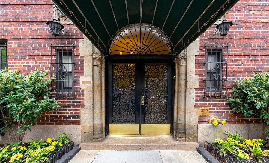 400 East 59th Street, Unit 10F Manhattan, NY 10022 - Photo 13 of 15 a front view of a building with a garden