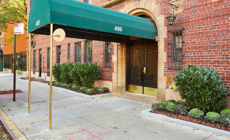 400 East 59th Street, Unit 10F Manhattan, NY 10022 - Photo 14 of 15 a front view of a house with a yard