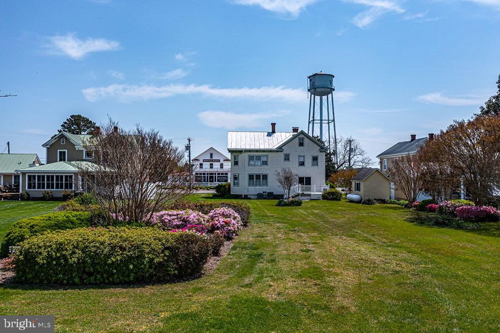 742 Main Street Reedville, VA 22539 - Photo 52 of 66 Charming homes amidst vibrant blooms.