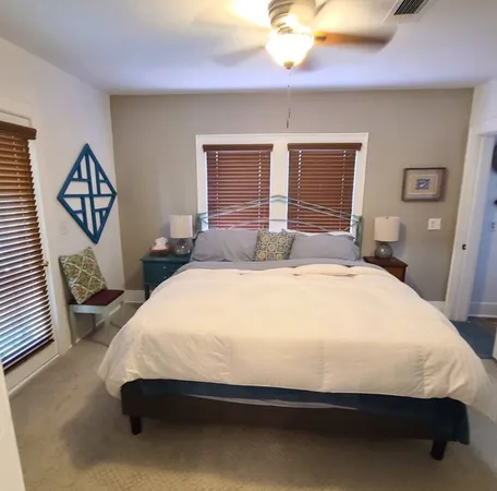 a large bed sitting in a bedroom next to a window
