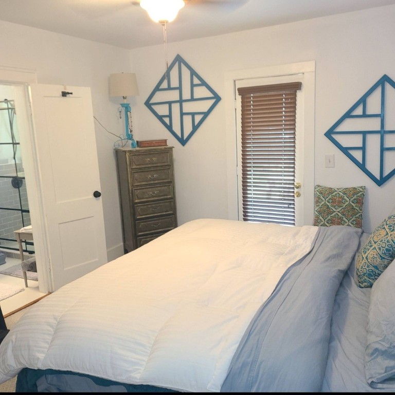 1427 Munger Street Houston, TX 77023 - Photo 12 of 24 a bedroom with a bed and dresser with wooden floor