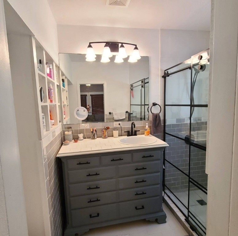 1427 Munger Street Houston, TX 77023 - Photo 14 of 24 a bathroom with a double vanity sink and a mirror