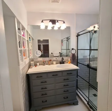 a bathroom with a double vanity sink and a mirror