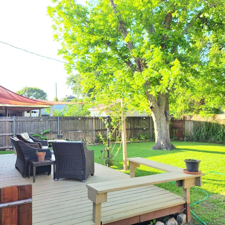 1427 Munger Street Houston, TX 77023 - Photo 22 of 24 a view of a patio with table and chairs potted plants and palm tree