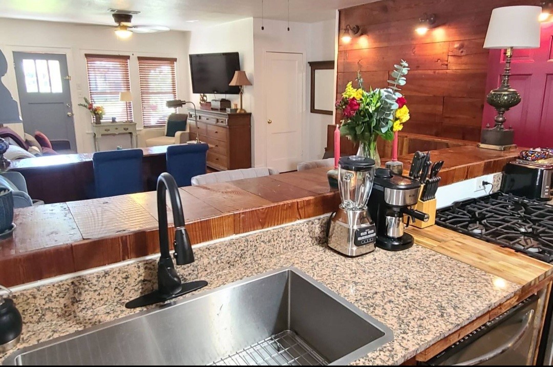 1427 Munger Street Houston, TX 77023 - Photo 6 of 24 a kitchen with a stove a sink and a dining table