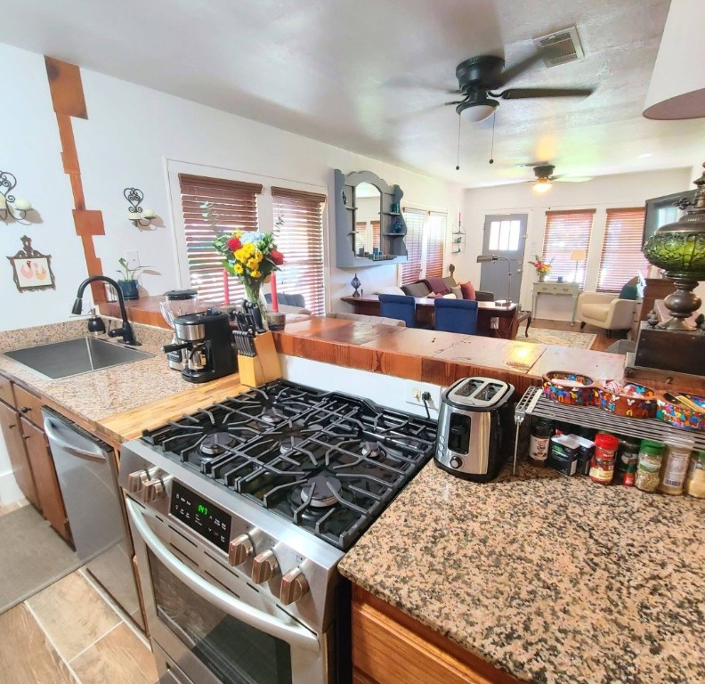 1427 Munger Street Houston, TX 77023 - Photo 7 of 24 a kitchen with a stove a sink and a dining table