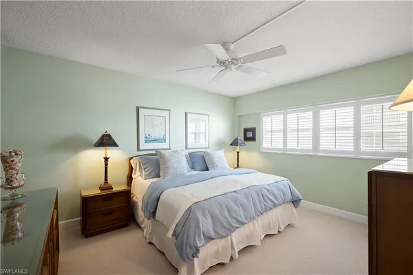 a bed room with a bed and a window