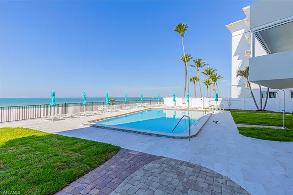 swimming pool with outdoor seating and garden