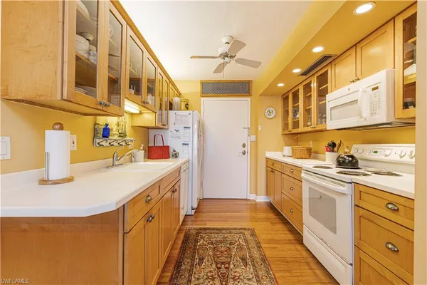 a kitchen with stainless steel appliances granite countertop a sink and cabinets