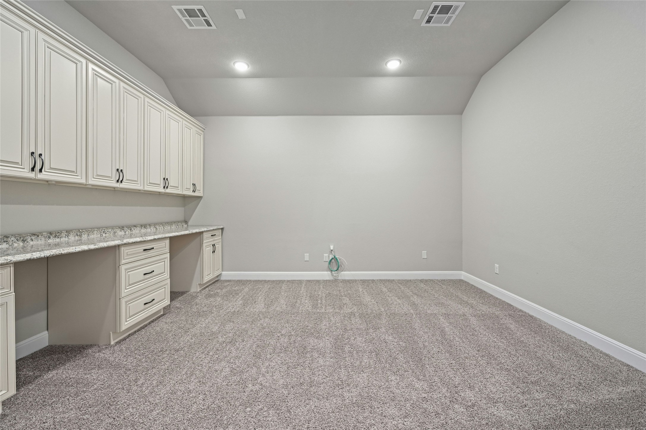 4124 Florentine Road Leander, TX 78641 - Photo 27 of 37 Unfurnished office featuring light colored carpet, built in desk, and vaulted ceiling