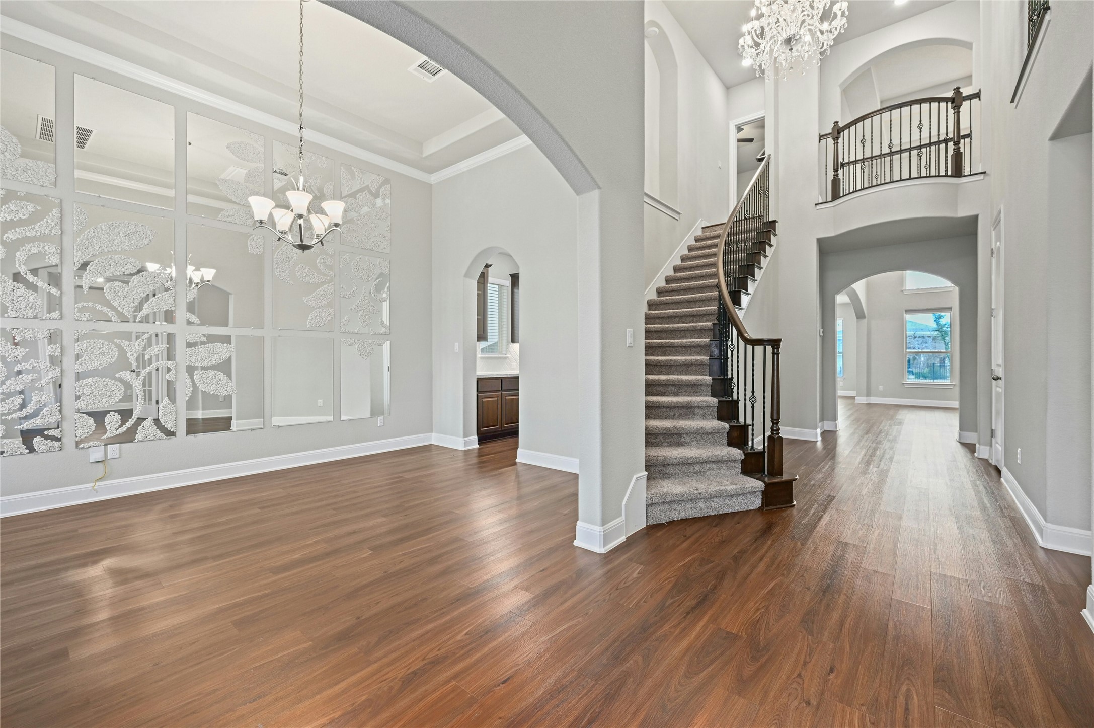 4124 Florentine Road Leander, TX 78641 - Photo 4 of 37 Foyer entrance featuring a towering ceiling, dark hardwood / wood-style flooring, ornamental molding, and a chandelier