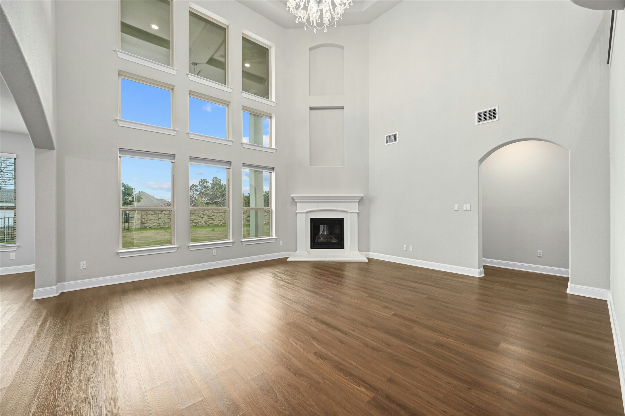4124 Florentine Road Leander, TX 78641 - Photo 6 of 37 Unfurnished living room featuring dark hardwood / wood-style floors, a high ceiling, and a chandelier