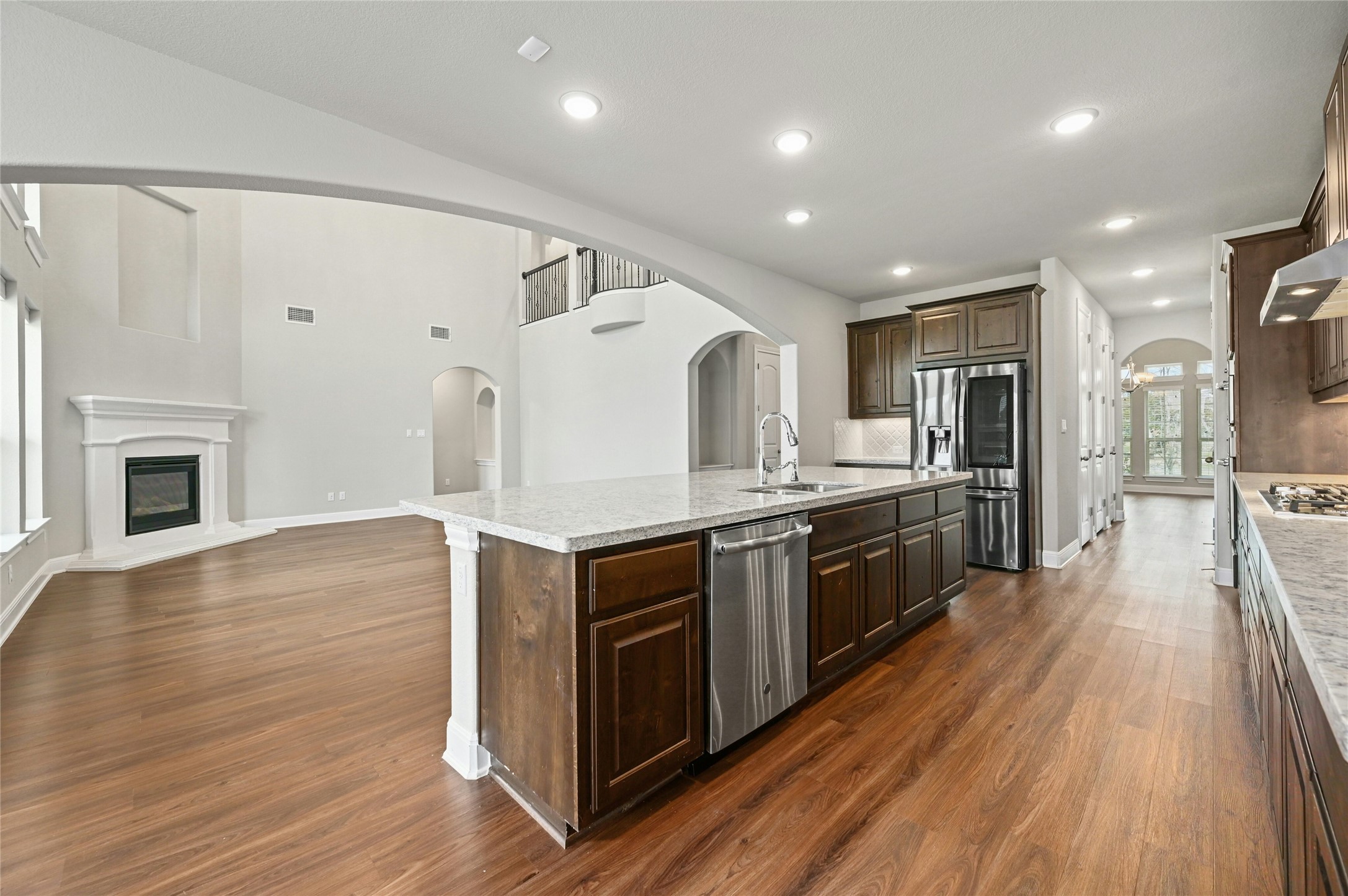 4124 Florentine Road Leander, TX 78641 - Photo 7 of 37 Kitchen featuring sink, dark brown cabinetry, a kitchen island with sink, dark wood-type flooring, and stainless steel appliances