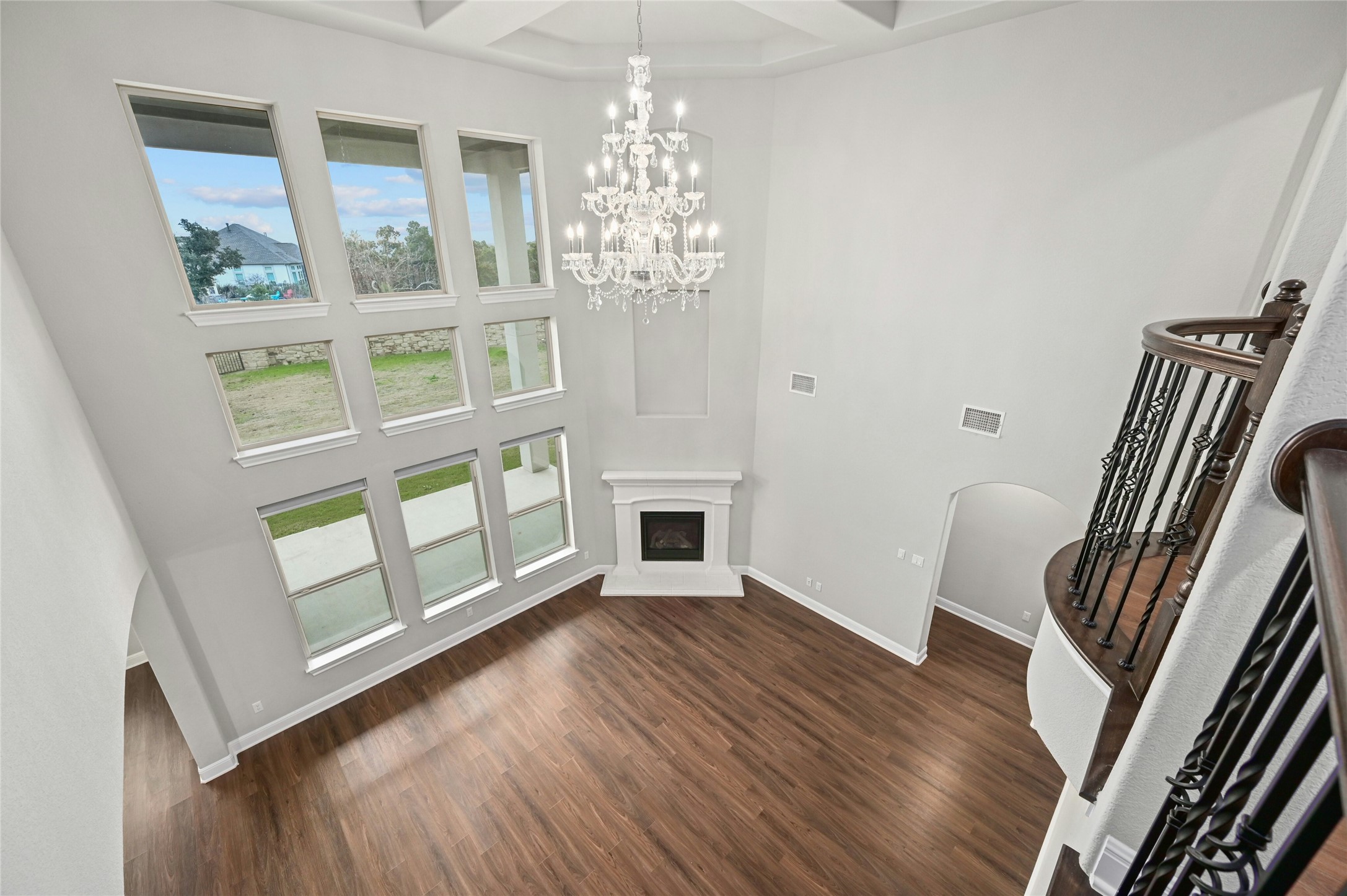 4124 Florentine Road Leander, TX 78641 - Photo 10 of 37 Living room with coffered ceiling, dark hardwood / wood-style flooring, a towering ceiling, a chandelier, and beam ceiling
