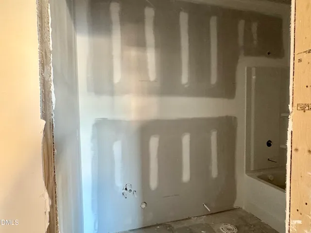 a kitchen with stainless steel appliances kitchen island granite countertop a refrigerator a stove a kitchen island a dining table and chairs with wooden floor