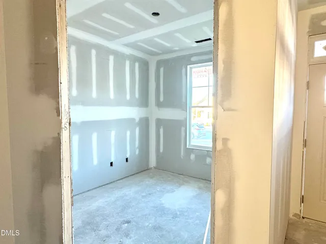 a view of a livingroom with wooden floor and a large window