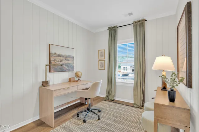 a kitchen with a table chairs refrigerator and cabinets
